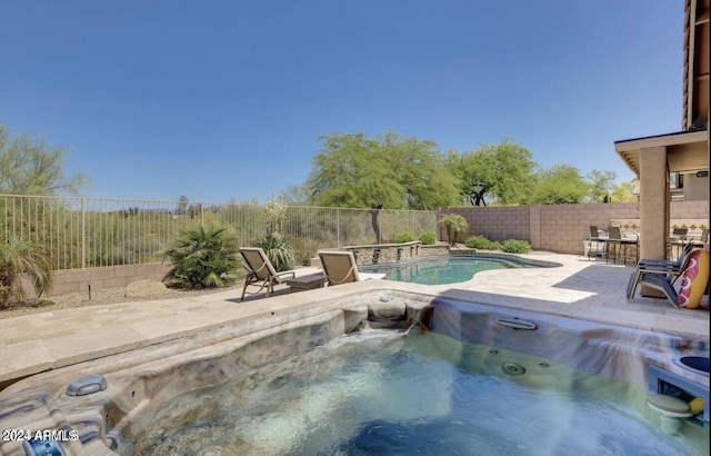 view of pool featuring an outdoor hot tub and a patio area