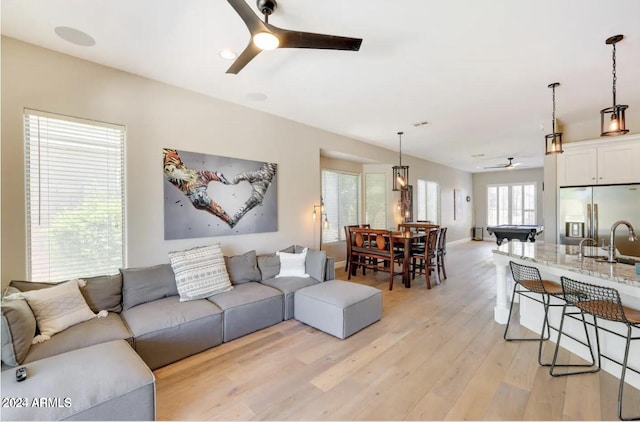 living room featuring ceiling fan, pool table, and light hardwood / wood-style flooring