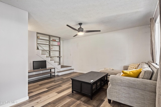 8538 E Portland St, Scottsdale, AZ 85257 - living room with wood finished floors, a ceiling fan, stairway, a textured ceiling, and concrete block wall