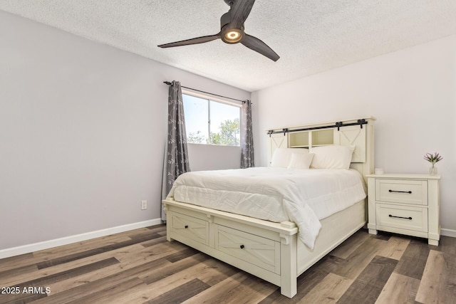 8538 E Portland St, Scottsdale, AZ 85257 - bedroom with a textured ceiling, baseboards, wood finished floors, and a ceiling fan
