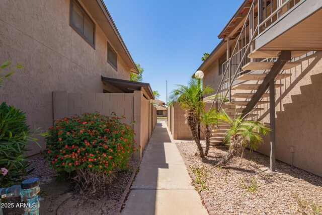 8538 E Portland St, Scottsdale, AZ 85257 - view of side of property featuring stairway and stucco siding
