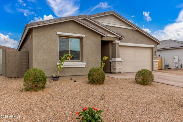 ranch-style home with a garage, concrete driveway, a tiled roof, and stucco siding