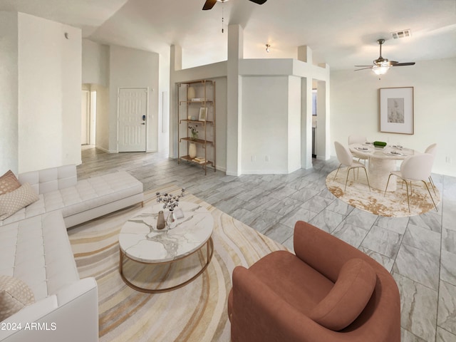 living room with light wood-type flooring, lofted ceiling, and ceiling fan