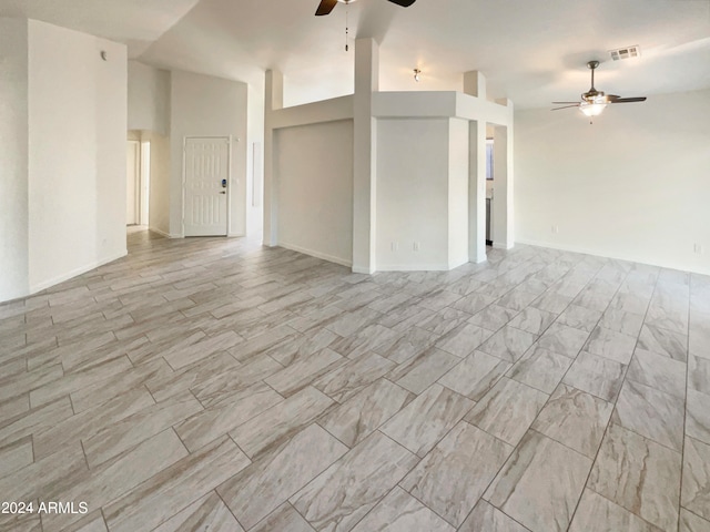 unfurnished living room with lofted ceiling and ceiling fan