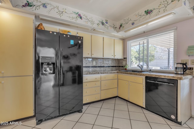 kitchen featuring light tile patterned flooring, sink, decorative backsplash, and black appliances