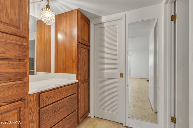 bathroom featuring tile patterned floors, vanity, and a notable chandelier