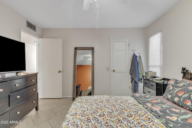 tiled bedroom featuring ceiling fan