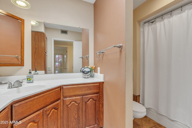 full bathroom featuring shower / tub combo, vanity, toilet, and tile patterned flooring