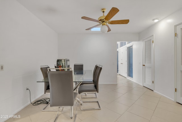 tiled dining room featuring ceiling fan