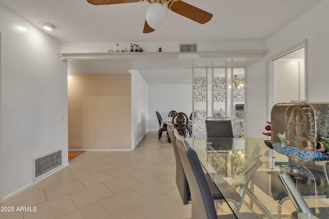 unfurnished dining area featuring light tile patterned floors and ceiling fan