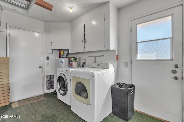 washroom featuring washer and dryer, cabinets, ceiling fan, and a textured ceiling