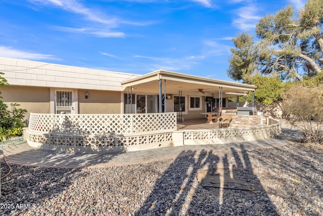 view of front of house with ceiling fan, exterior kitchen, and a patio