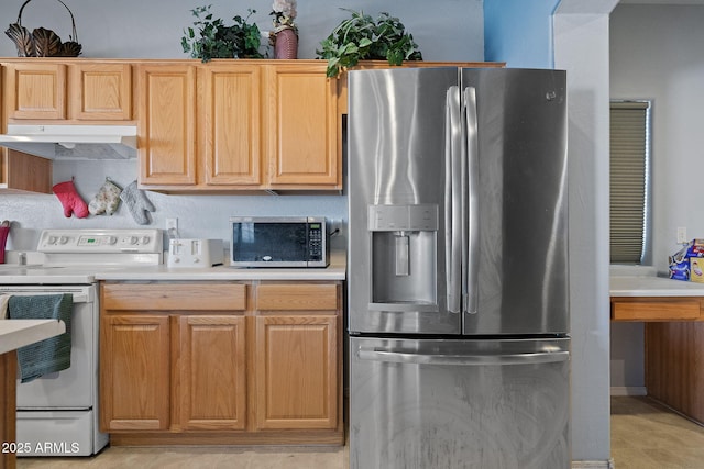 kitchen with appliances with stainless steel finishes and light brown cabinetry