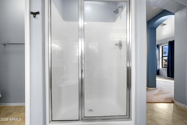 bathroom with a shower with shower door