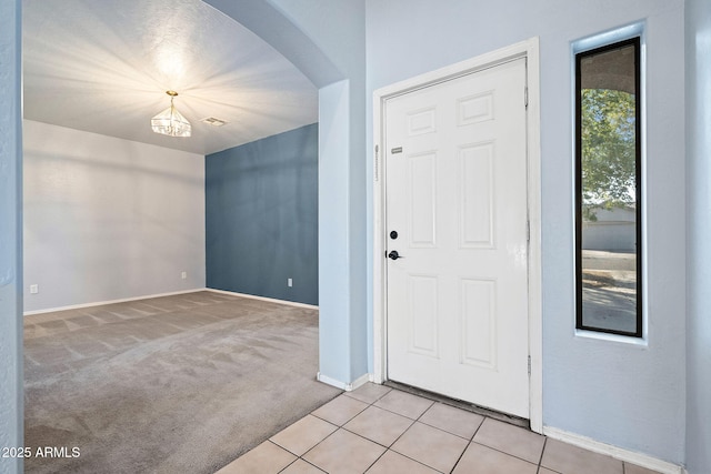 view of carpeted foyer entrance