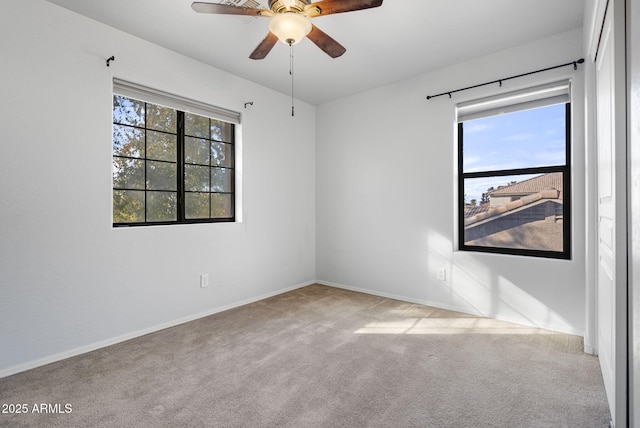 empty room featuring light carpet and ceiling fan