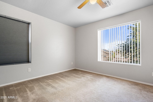 carpeted spare room with ceiling fan