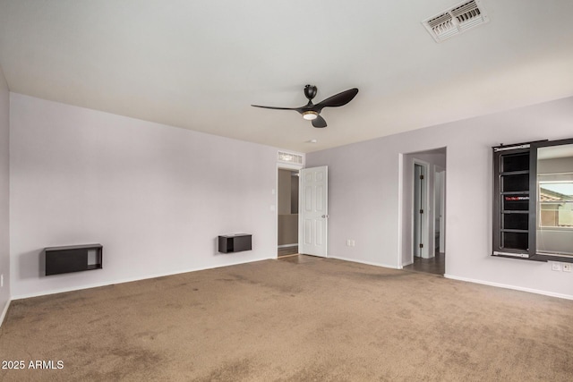 interior space featuring baseboards, visible vents, ceiling fan, and carpet flooring