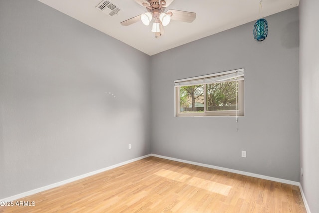 empty room featuring light wood-style flooring, baseboards, and visible vents