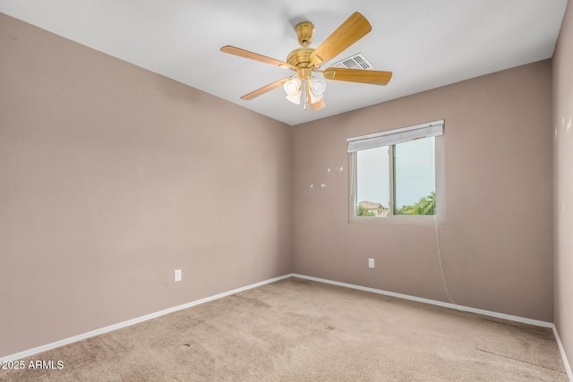 carpeted spare room featuring a ceiling fan, baseboards, and visible vents