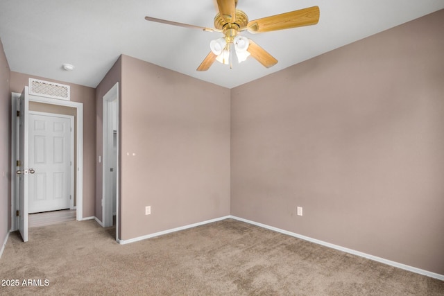 unfurnished bedroom with baseboards, ceiling fan, visible vents, and light colored carpet