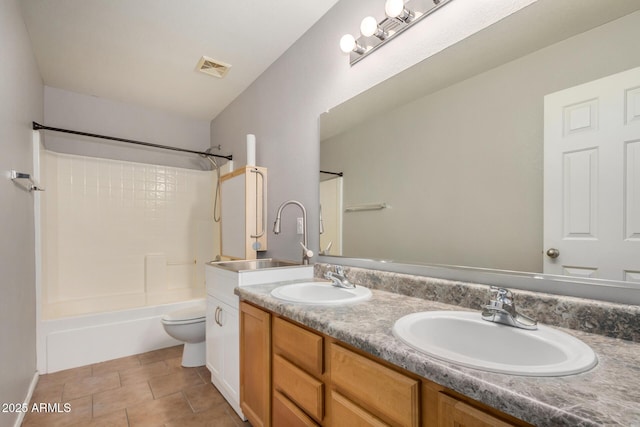 bathroom with double vanity, a sink, toilet, and bathing tub / shower combination
