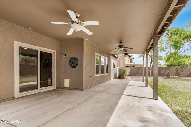 view of patio with a ceiling fan and fence