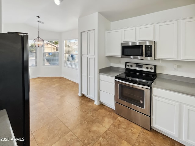 kitchen with vaulted ceiling, appliances with stainless steel finishes, decorative light fixtures, white cabinets, and a chandelier