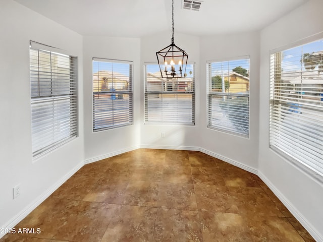 unfurnished dining area with a notable chandelier