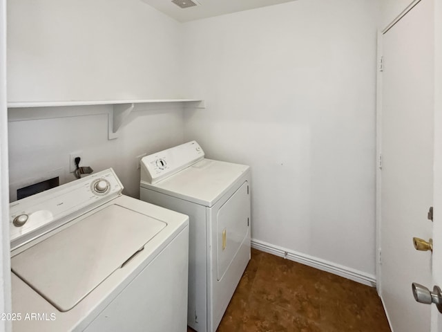 clothes washing area featuring separate washer and dryer