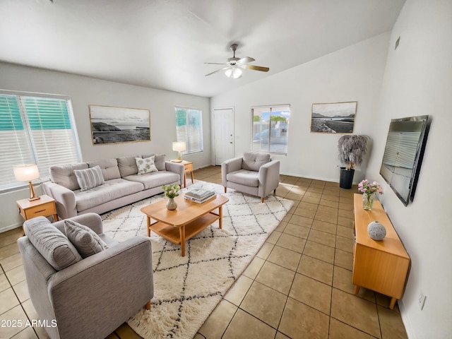 living room with ceiling fan, lofted ceiling, and tile patterned floors