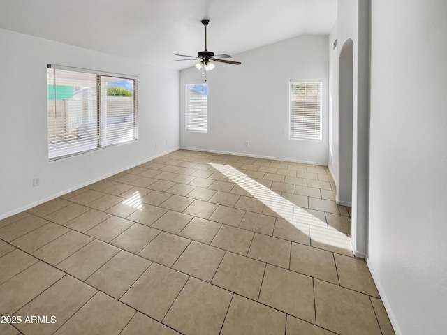 tiled empty room with lofted ceiling and ceiling fan