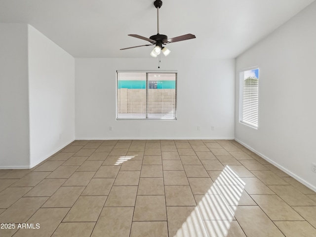 tiled spare room with ceiling fan