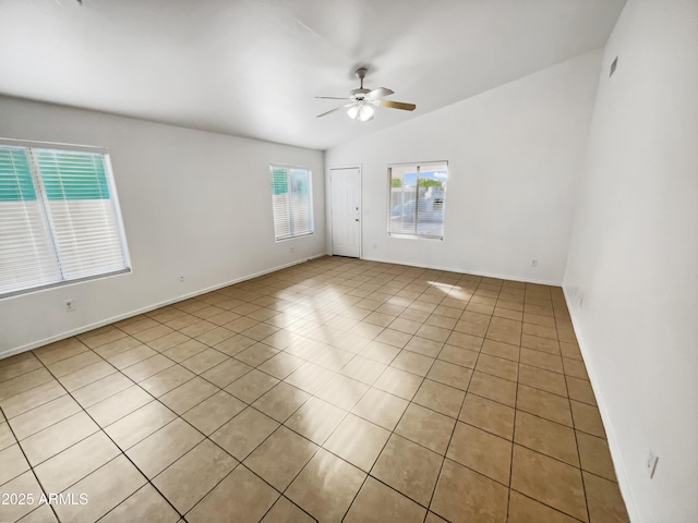 spare room featuring vaulted ceiling, ceiling fan, and light tile patterned flooring