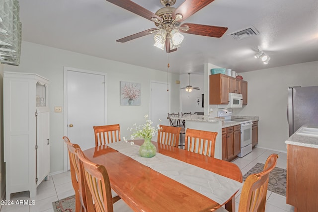 dining room with light tile patterned floors and ceiling fan