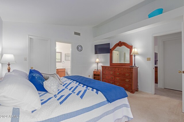 8140 N 107th Ave Unit 129, Peoria, AZ 85345 - bedroom with lofted ceiling, light carpet, and ensuite bath