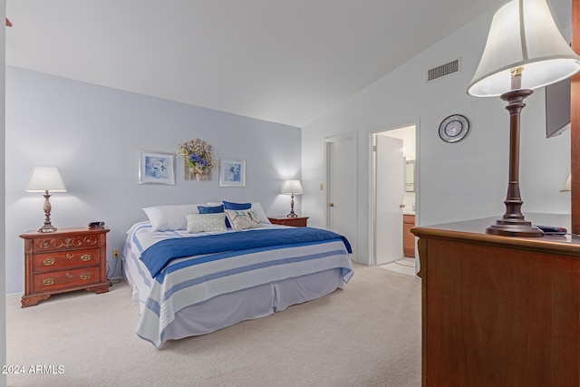 carpeted bedroom featuring ensuite bath and lofted ceiling