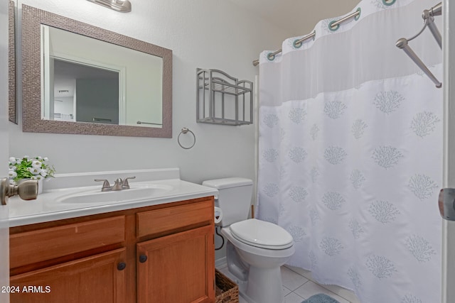 bathroom with tile patterned flooring, vanity, and toilet