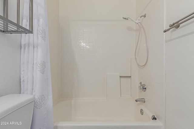 bathroom with shower / tub combo with curtain and toilet