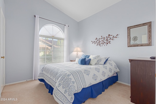 carpeted bedroom featuring lofted ceiling