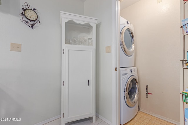 laundry area featuring stacked washer / drying machine