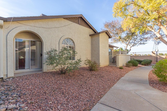 8140 N 107th Ave Unit 129, Peoria, AZ 85345 - view of home's exterior with stucco siding and a gate