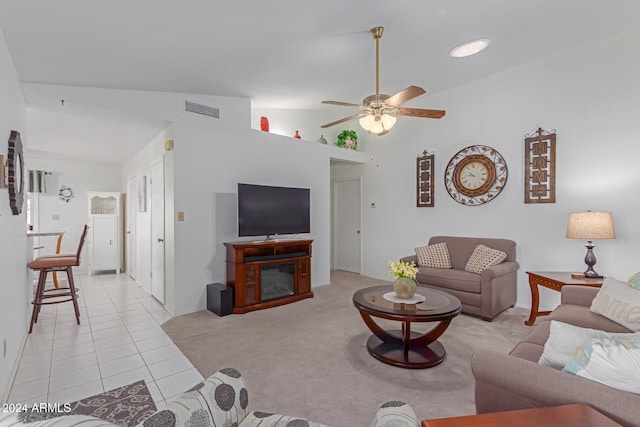 living room with light tile patterned floors, vaulted ceiling, and ceiling fan