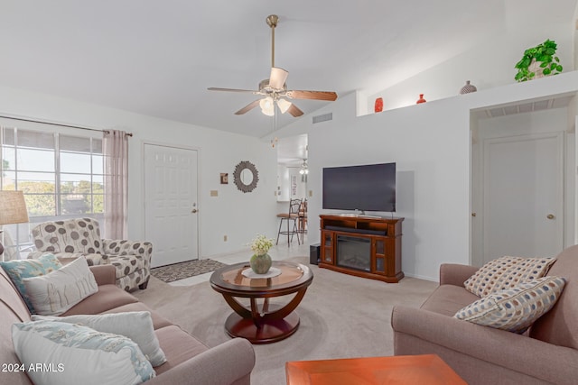 carpeted living room with ceiling fan and high vaulted ceiling