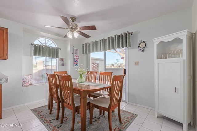 tiled dining space with ceiling fan