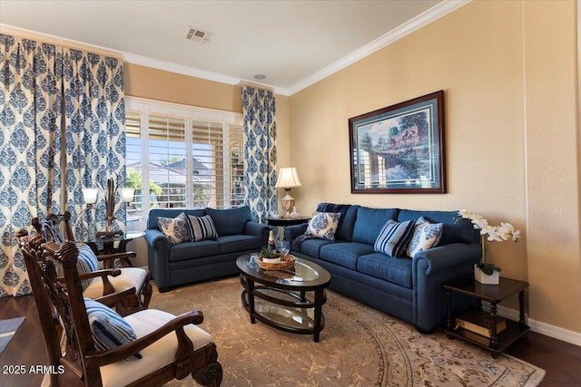 living room with ornamental molding, wood finished floors, visible vents, and baseboards