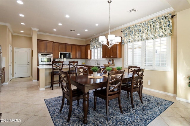 dining space featuring light tile patterned floors, baseboards, visible vents, and crown molding