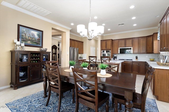 dining room with ornamental molding, light tile patterned flooring, and visible vents