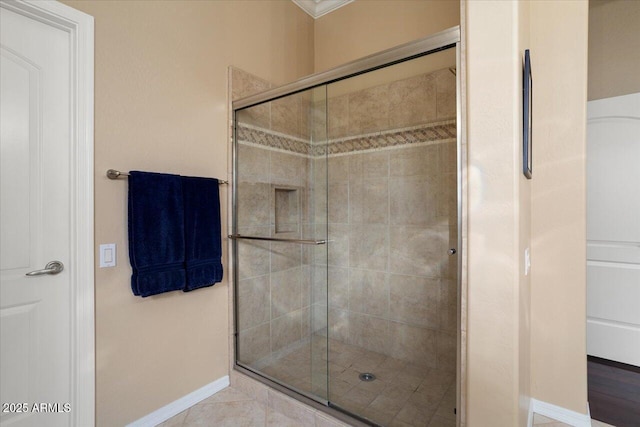 full bathroom featuring a stall shower and baseboards