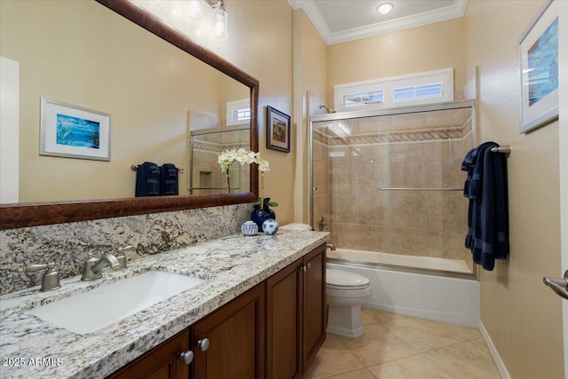 bathroom featuring bathing tub / shower combination, toilet, ornamental molding, vanity, and tile patterned flooring